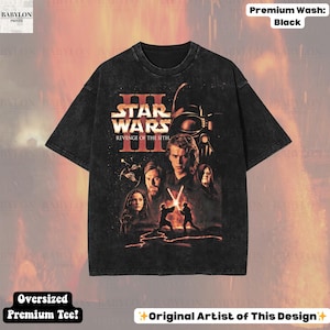 May include: Black oversized premium tee featuring a Star Wars: Revenge of the Sith graphic. The design includes characters like Darth Vader, Anakin Skywalker, and Obi-Wan Kenobi. The shirt has a distressed look and the text "Original Artist of This Design".