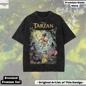May include: Black oversized premium tee featuring a colorful graphic of Disney's Tarzan. The design includes Tarzan, Jane, gorillas, and an elephant. The shirt has the text "Disney Tarzan" across the top.
