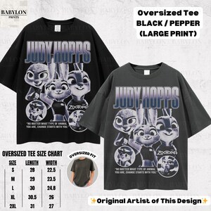 May include: Two oversized black and pepper-colored t-shirts with a large print of Judy Hopps from Zootopia. The shirts feature the text "JUDY HOPPS" and the quote "NO MATTER WHAT TYPE OF ANIMAL YOU ARE, CHANGE STARTS WITH YOU."