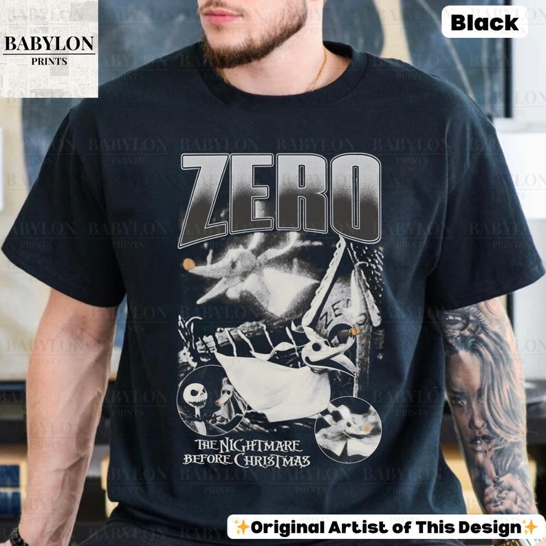 May include: Black t-shirt featuring a graphic from "The Nightmare Before Christmas" with the word "ZERO" in large letters. The design includes images of Zero, Jack Skellington, and other characters from the movie. The shirt also has the text "Original Artist of This Design".