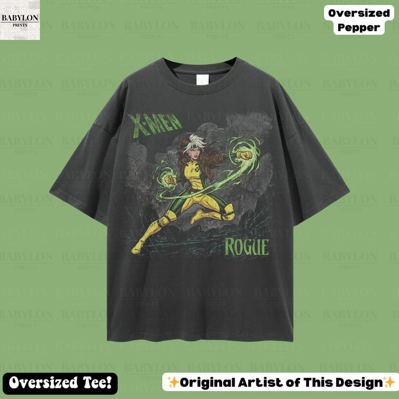 May include: Dark grey oversized t-shirt with a graphic of the X-Men character Rogue, depicted in a dynamic pose with green energy effects. The shirt features the text "X-MEN" and "ROGUE" in green.