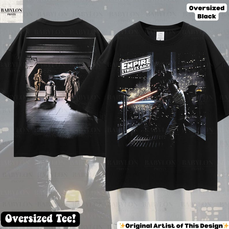 May include: Black oversized tee shirt featuring scenes from "The Empire Strikes Back." The front of the shirt displays a battle scene with lightsabers, while the back shows characters in a hallway. The shirt has the text "The Empire Strikes Back."