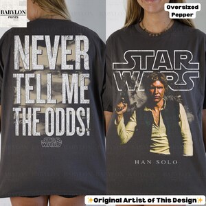 Puede incluir: Camiseta gris oscuro de gran tama&ntilde;o con un dise&ntilde;o de Star Wars. La parte delantera muestra a Han Solo con el logo de Star Wars, y la parte trasera dice "Never Tell Me The Odds!". La camiseta tiene un aspecto vintage.