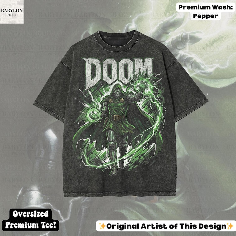May include: Dark gray oversized premium tee featuring a graphic of a character with the word "DOOM" in white. The character is in green and black, surrounded by green lightning. The shirt has the text "Premium Wash: Pepper" and "Oversized Premium Tee!"