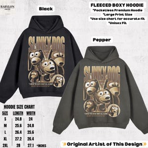 May include: Black and pepper-colored fleeced boxy hoodies with a Slinky Dog graphic. The design includes the text "Slinky Dog" and the quote "I knew you were right all along, Woody never doubted ya." The hoodies are unisex fit.