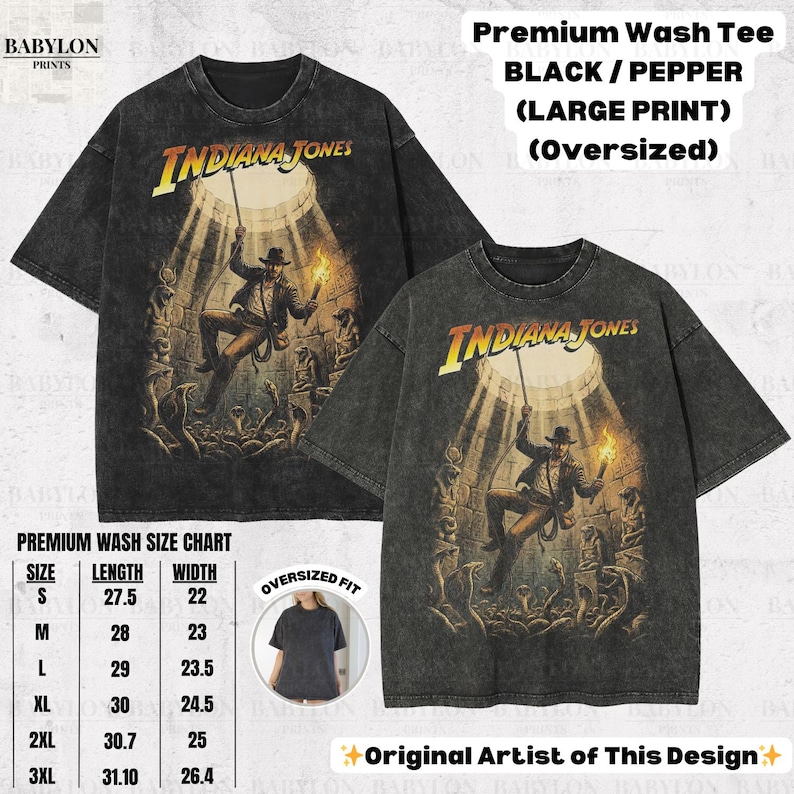 May include: Two black oversized t-shirts with a distressed graphic of Indiana Jones. The shirts feature the text "Indiana Jones" in yellow and a size chart. The shirts are labeled "Premium Wash Tee".