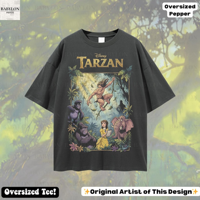 May include: Dark gray oversized t-shirt featuring a colorful Disney Tarzan graphic. The graphic includes Tarzan, Jane, gorillas, and an elephant. Text on the shirt reads "Disney Tarzan". Additional text includes "Oversized Pepper" and "Oversized Tee!"