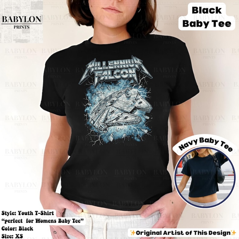 May include: Black youth t-shirt featuring a graphic of the Millennium Falcon spaceship with the text "Millennium Falcon" in a stylized font. The design includes blue lightning effects. The shirt is labeled as a "Baby Tee" and is size XS.