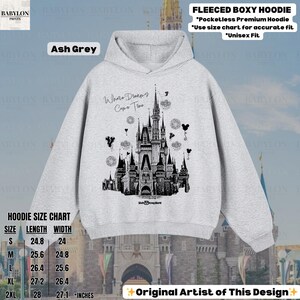 May include: Ash grey unisex fleece boxy hoodie with a black and white castle graphic. The hoodie features the text "Where Dreams Come True" and a size chart. The design is by the original artist.