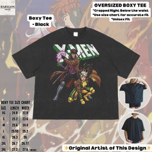 May include: Black oversized boxy tee featuring a graphic of X-Men characters. The shirt has the word "X-MEN" in green and white. The tee includes a size chart with measurements in inches. The design is labeled as "Original Artist of This Design."