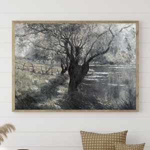 Puede incluir: Una pintura de paisaje en blanco y negro enmarcada que representa un árbol con un río en el fondo. La pintura está colgada en una pared blanca sobre un banco de madera con dos cojines. El banco está frente a una pared blanca con una ventana en el lado derecho.