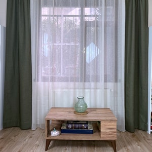 Khaki linen curtain on living room window.