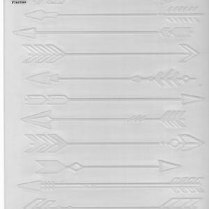 May include: A white Cricut Cuttlebug embossing folder featuring a collection of arrow designs. The folder includes various arrow styles, with detailed embossed patterns. The text "Arrows, Flèches, Flechas" is visible.