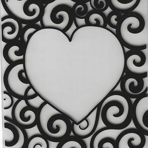 May include: A white rectangular frame with a heart-shaped cutout in the center. The frame is decorated with black swirling scrollwork. The design is symmetrical and elegant.