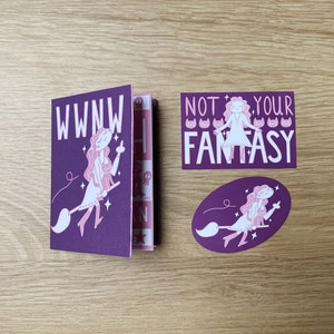 May include: A set of three purple stickers featuring a witch on a broomstick. The stickers have the text "WWNW" and "NOT YOUR FANTASY" with a row of cat faces.