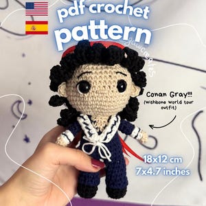 May include: A crochet doll of Conan Gray in a navy blue sailor-style outfit with a white collar and tie, black curly hair, and black eyes. The text reads pdf crochet pattern, Conan Gray!!! (wishbone world tour outfit), 7x4.7 inches, instant download.