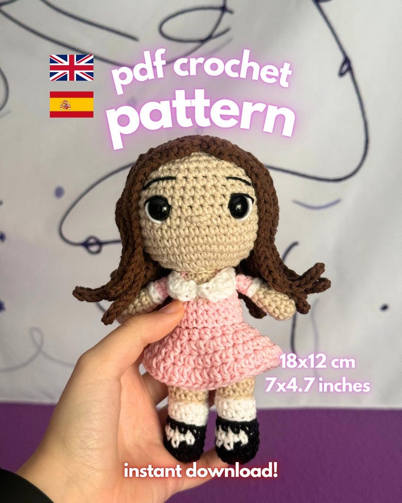 May include: A crocheted doll with brown hair, a tan face, and a pink dress. The doll is 7 inches tall and 4.7 inches wide. The image includes the text "pdf crochet pattern" and "instant download!"