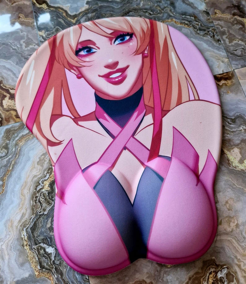 May include: A pink and black wrist rest with a cartoon image of a woman with blonde hair and blue eyes. The woman is wearing a pink and black outfit with a pink ribbon.