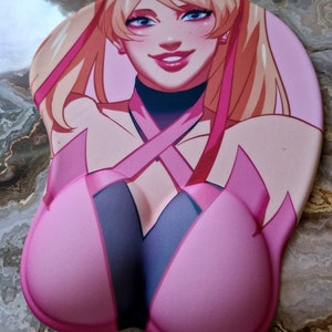 May include: A pink and black mousepad with a cartoon image of a woman with long blonde hair wearing a pink and black outfit. The mousepad has a raised, ergonomic design.