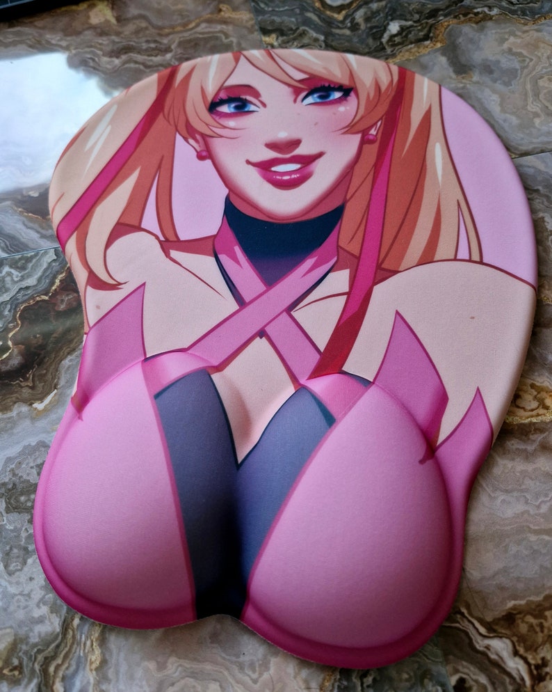 May include: A pink and black mousepad with a cartoon image of a woman with long blonde hair wearing a pink and black outfit. The mousepad has a raised, ergonomic design.