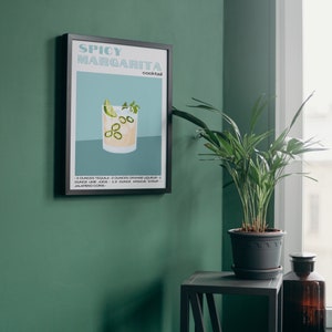 May include: A black framed poster with a white background and the text "Spicy Margarita cocktail" in a blue and green font. The poster features a glass of margarita with a lime wedge, cilantro, and jalapeno slices. The recipe is listed below the image.