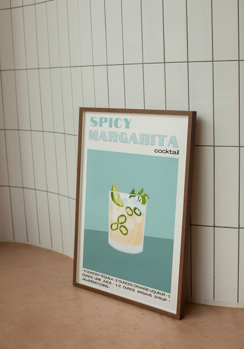 May include: A framed illustration of a spicy margarita cocktail recipe. The illustration features a glass of margarita with lime wedges, jalapeno slices, and ice. The text reads "Spicy Margarita Cocktail" and includes the ingredients: 3 ounces tequila, 2 ounces orange liqueur, 1 ounce lime juice, 1/2 ounce agave syrup, and jalapeno coins.