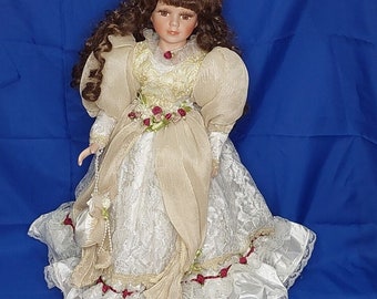 J. Misa 18 inch Porcelain Doll Brown Hair Brown Eyes Silk Dress on stand