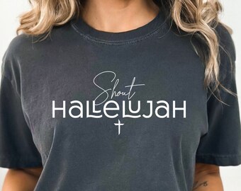 May include: A dark gray t-shirt with the text "Shout Hallelujah" in white lettering with a small cross underneath.