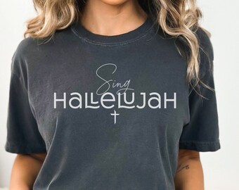 May include: A dark gray t-shirt with the text "Sing Hallelujah" in white lettering with a small cross underneath.