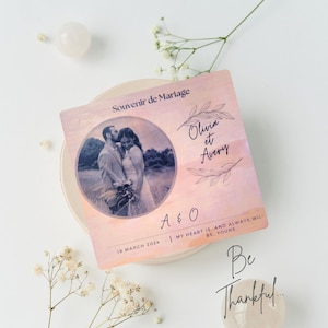 May include: A wedding souvenir with a photo of a couple in a field, a watercolor background, and the text "Souvenir de Mariage", "Olivia et Avery", "A & O", "19 March 2024", "My heart is, and always will be, yours." and "Be Thankful..."