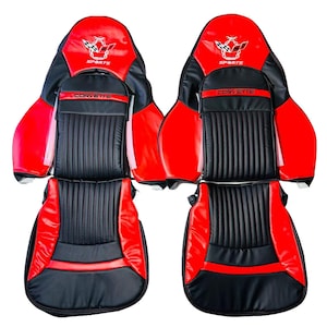 May include: Two black and red leather car seat covers with the word "Corvette" and "Sports" embroidered on them.