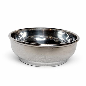 May include: A shiny, stainless steel bowl with a rounded base and a smooth, reflective surface. The bowl has a simple, elegant design, perfect for serving or display. The rim is slightly thicker than the rest of the bowl.