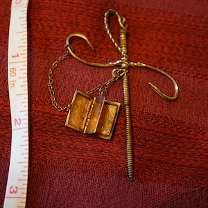 Vintage scarf pin, gold plated sword with locket, locket marked sterling