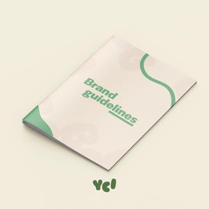 Könnte beinhalten: Ein Broschüre mit den Worten "Brand guidelines" in grüner Schrift auf dem Cover. Das Cover ist cremefarben mit einem grünen Wellenmuster. Die Broschüre liegt auf einem hellbeigen Hintergrund. Das Logo "ycl" befindet sich unten.