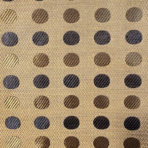 May include: A gold fabric with a repeating pattern of black and brown circles.