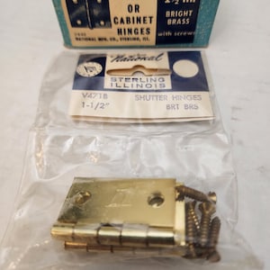 May include: A package of 10 brass shutter or cabinet hinges, 1 1/2 inches in size, with screws. The package is labeled "National Sterling Illinois" and "V471B".