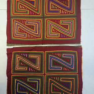 May include: Two rectangular textile panels with a repeating geometric design. Each panel features four squares with a central 'Z' shape, outlined in various colors including orange, green, blue, and pink, on a maroon background.