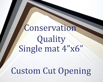 May include: A stack of white, beige, brown, gray, and black mat boards with a custom cut opening. The text "Conservation Quality Single mat 4" x 6" Custom Cut Opening" is printed on the mat boards.