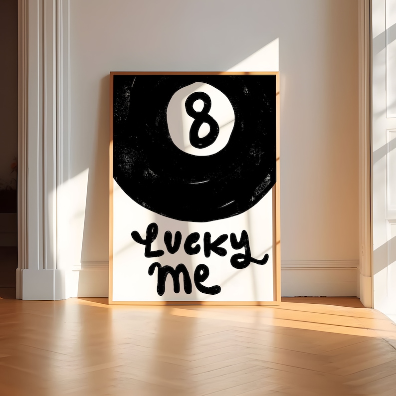 May include: A black and white poster with a black 8-ball and the text "Lucky Me" in a white cursive font.