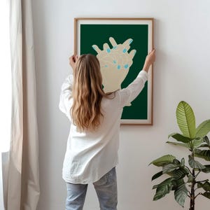 May include: A framed illustration of two hands with blue nail polish on a dark green background.