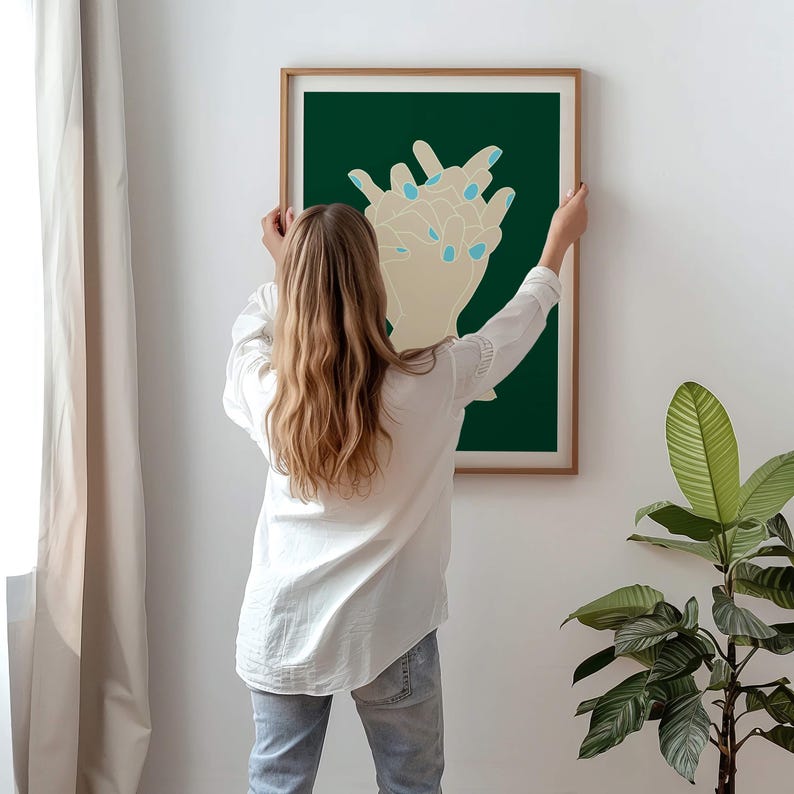 May include: A framed illustration of two hands with blue nail polish on a dark green background.