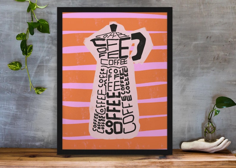 May include: A framed print with an orange and pink striped background. The print features a stylized image of a coffee pot made up of the word "coffee" repeated many times.