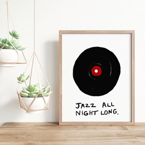 May include: A framed print with a black and white illustration of a vinyl record with a red center. The text "JAZZ ALL NIGHT LONG." is written in black below the record.