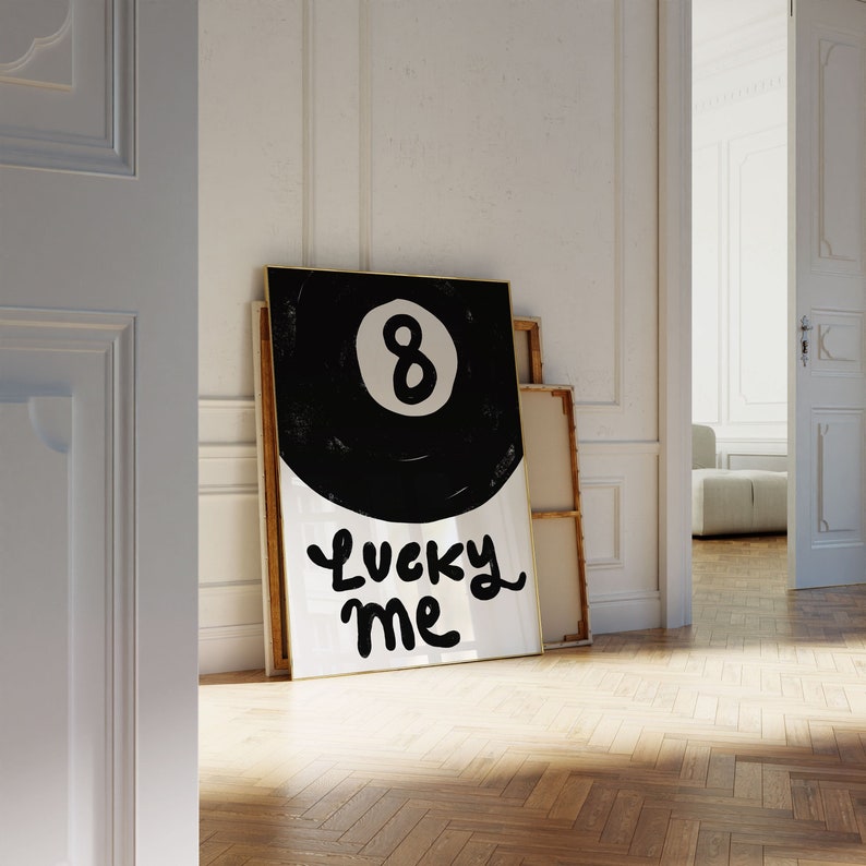 May include: A black and white poster with a black 8-ball and the text "Lucky Me" in white.
