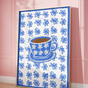 May include: A blue and white teacup with brown liquid inside, on a white background with a blue floral pattern.