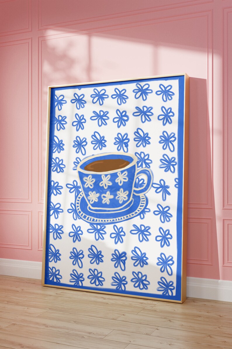 May include: A blue and white teacup with brown liquid inside, on a white background with a blue floral pattern.