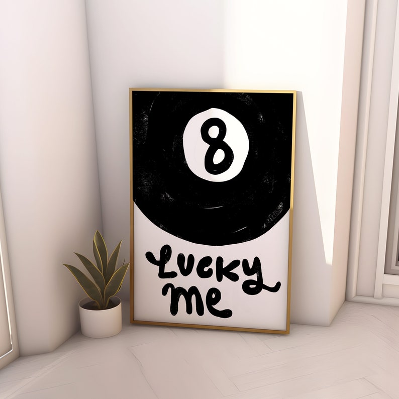May include: Black and white illustration of a pool ball with the number 8 on it. The text "Lucky Me" is written below the ball.