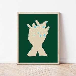 May include: Two hands with light blue nail polish are intertwined against a dark green background.