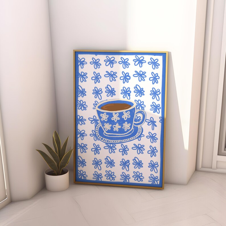 May include: A framed print of a blue coffee cup with white flowers on a white background with a blue flower pattern.