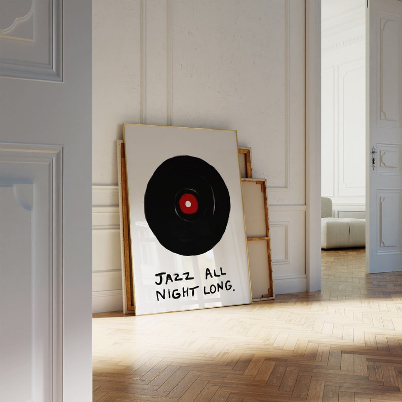 May include: A framed print with a black and white illustration of a vinyl record with a red center. The text "JAZZ ALL NIGHT LONG." is written in black below the record.